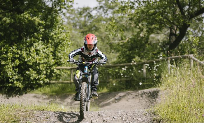 Small kid riding the pump track
